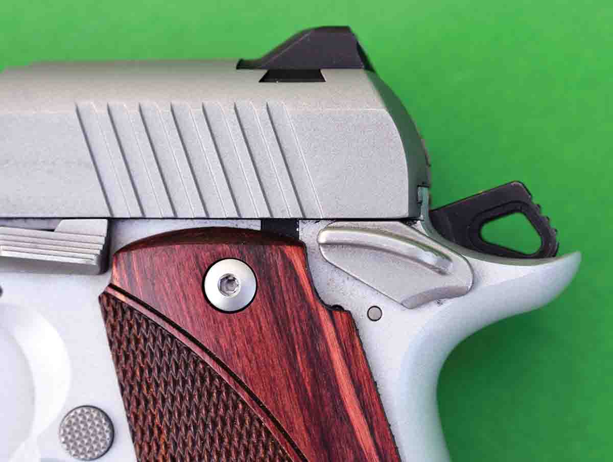 The Kimber Micro 9 features a right-hand safety, which is shown in the “on” position and with the hammer cocked.